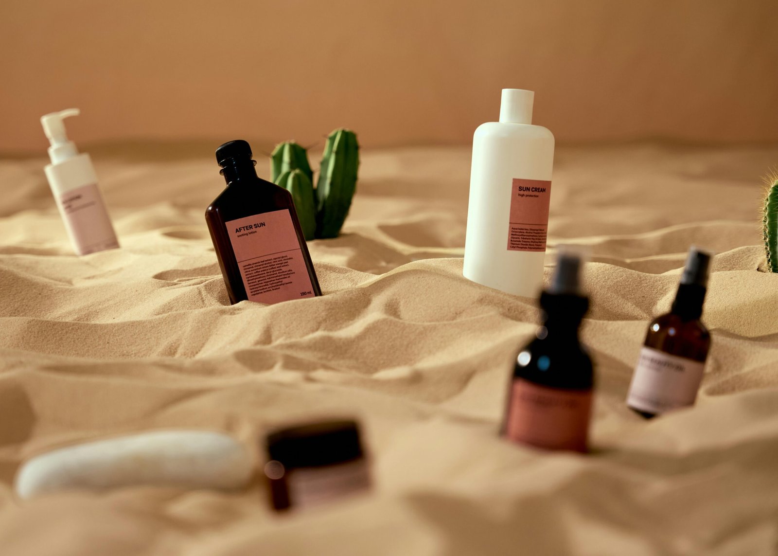 beauty products in sand