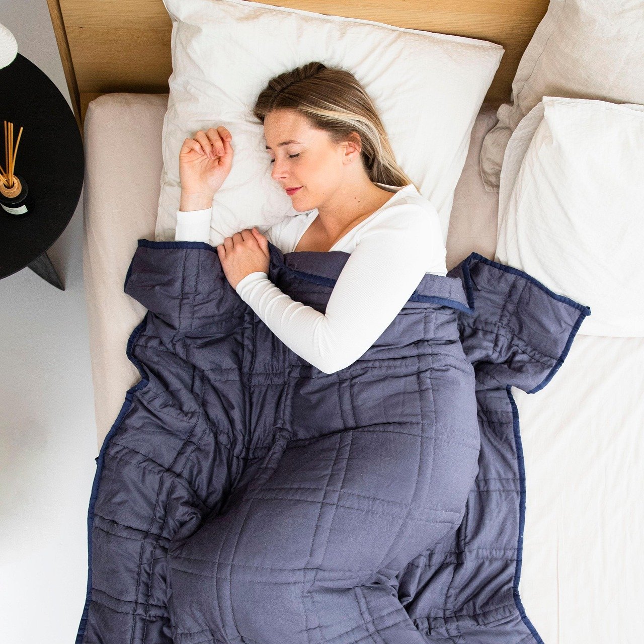 woman sleeping with weighted blanket